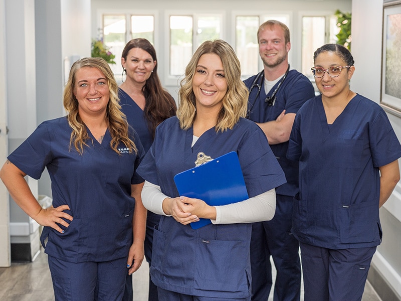 smiling nurses holding paperwork