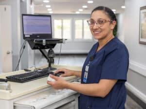 smiling nurse working on a computer