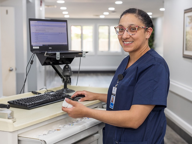 smiling nurse working on a computer