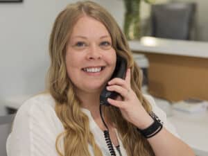 employee smiling while talking on the phone