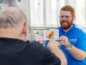 presidential post acute employee assisting an elderly resident during an activity