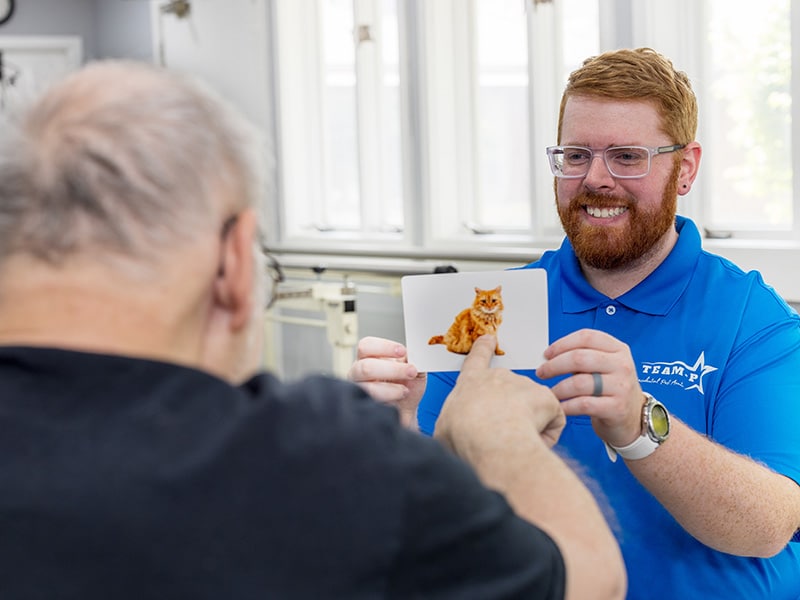 presidential post acute employee assisting an elderly resident during an activity